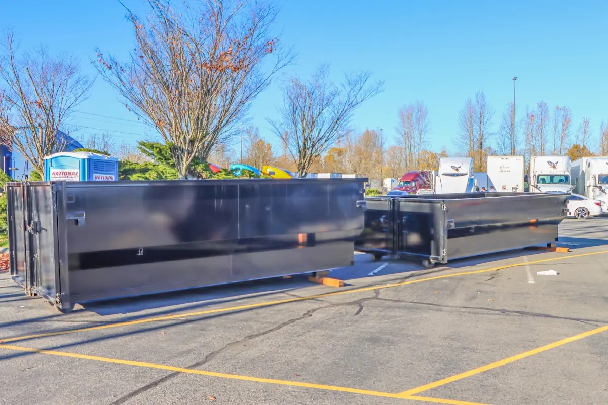 Professional dumpster rental service with roll-off container on residential driveway in Rockport